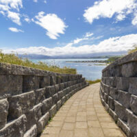 Path of Kaikoura Peninsula Walkway with stone brick wall